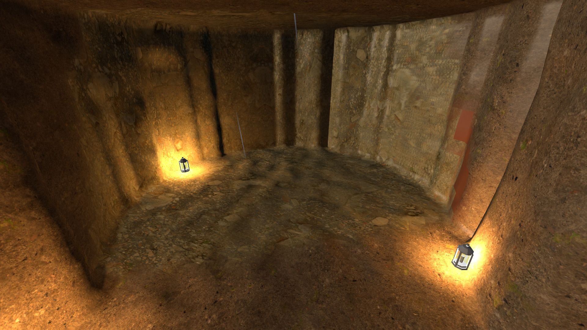An empty rounded chamber cut into rock, walls marked with pick strokes, lit by two lanterns